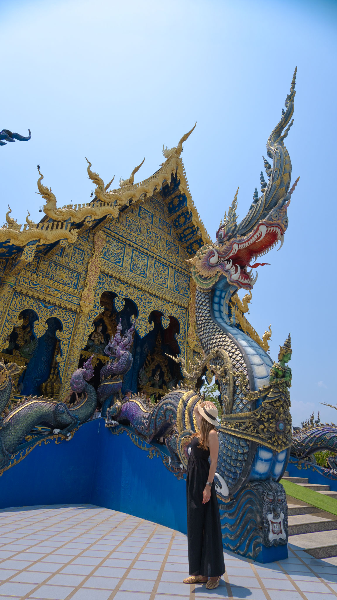 Woman visiting the Blue Temple, Wat Rong Suea Ten, in Chiang Rai, Thailand